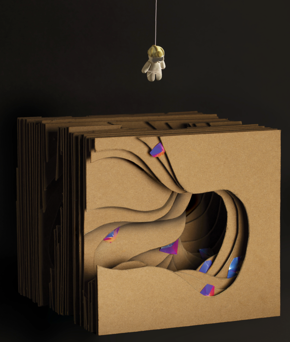 final design of layered cardboard to imitate a cave and a hanging climber