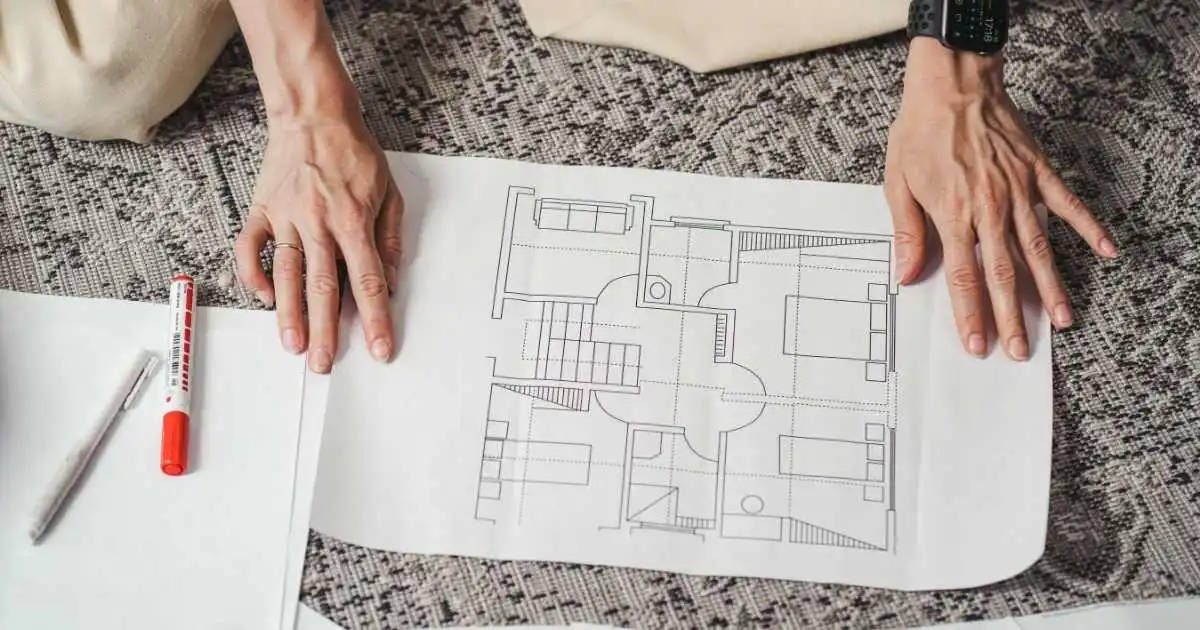 Person Holding a Floor Plan