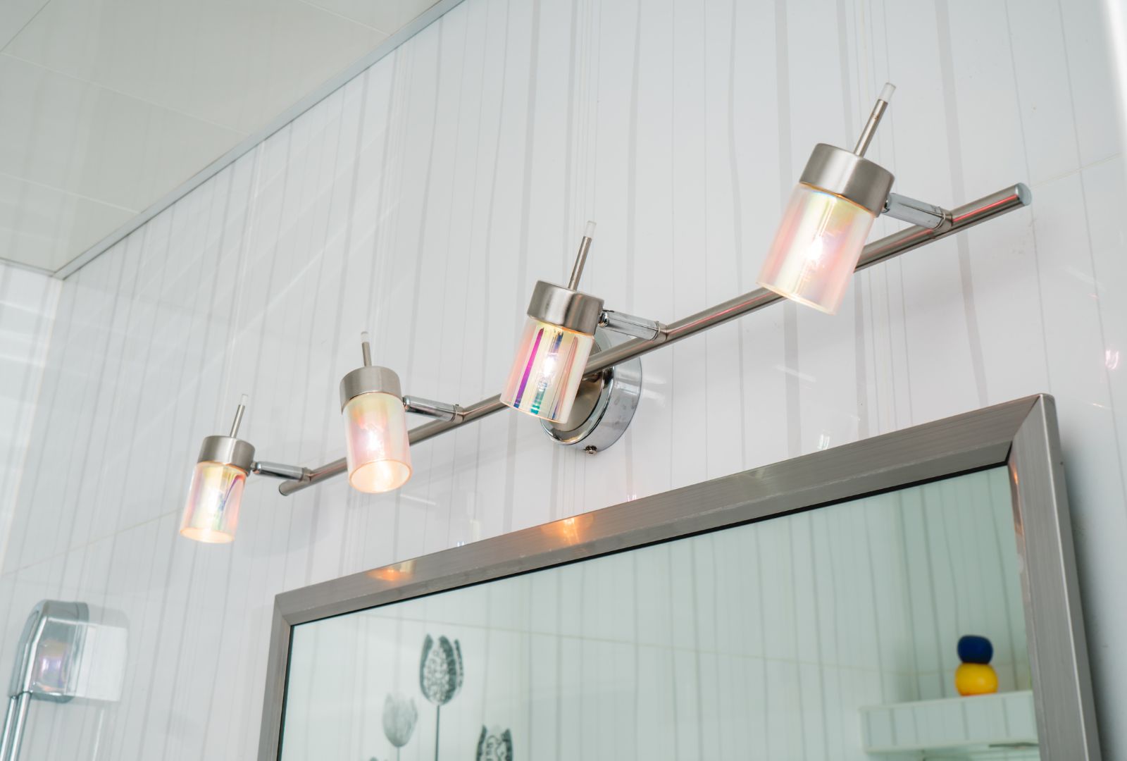 lighting fixtures in the bathroom over a mirror