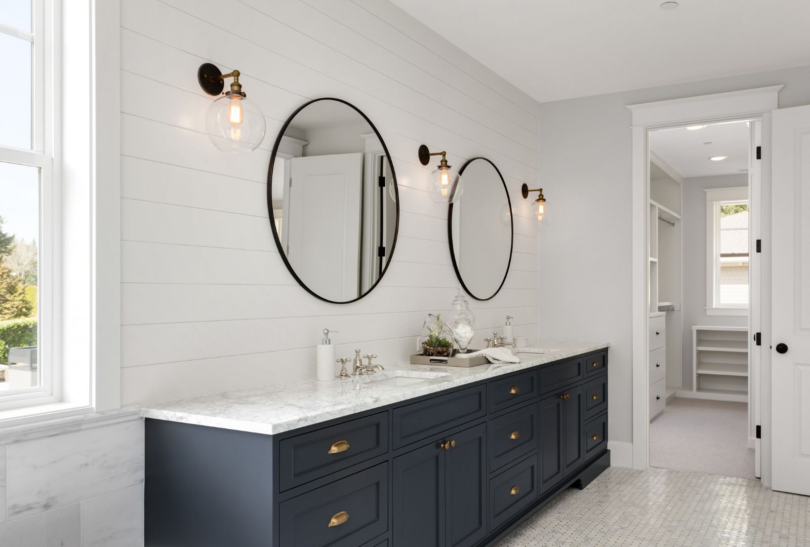 Bathroom in New Luxury Home with Two Sinks and Wall Sconces