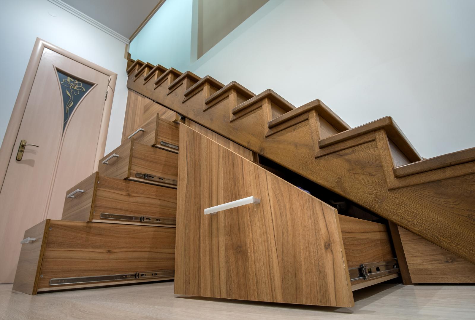 Custom Built Pullout Cabinets on Glides in Slots under Stairs. Use of Space for Storage.