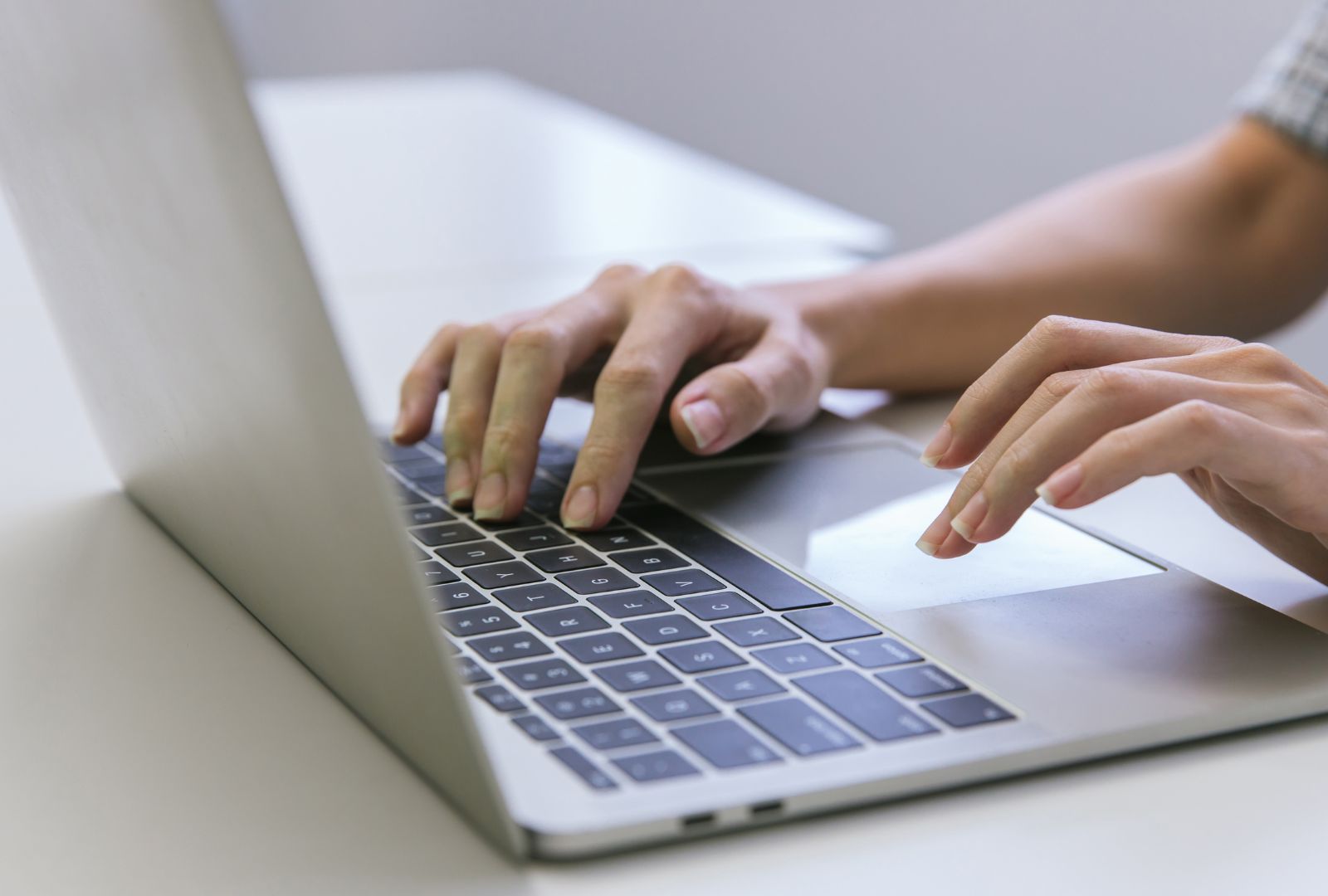 Woman hand using laptop searching for remodelers.