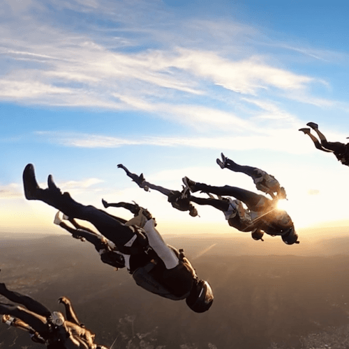 a freefall picture of a large angle group during sunset