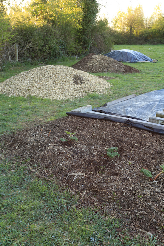 Piles of woodchip and compost, for later use mostly