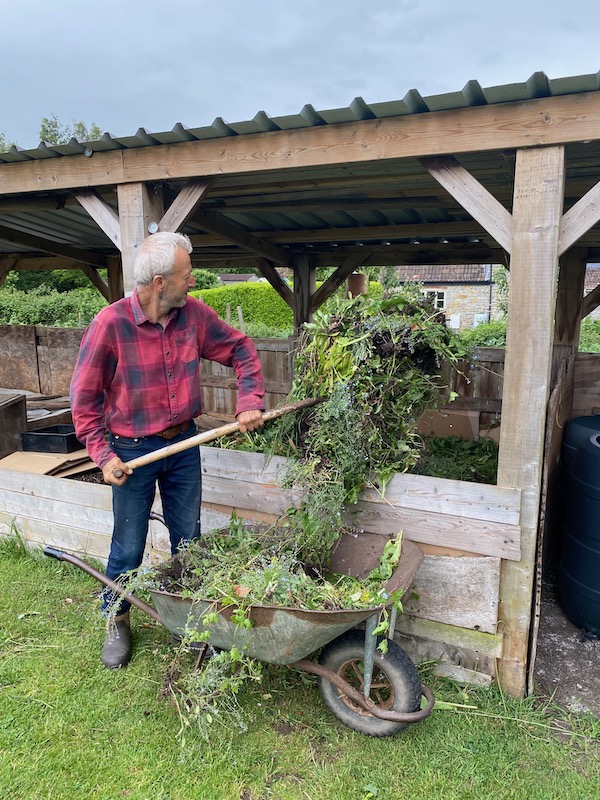 I am loading a collection of seeding flowers, bindweed roots and other weeds from the front garden