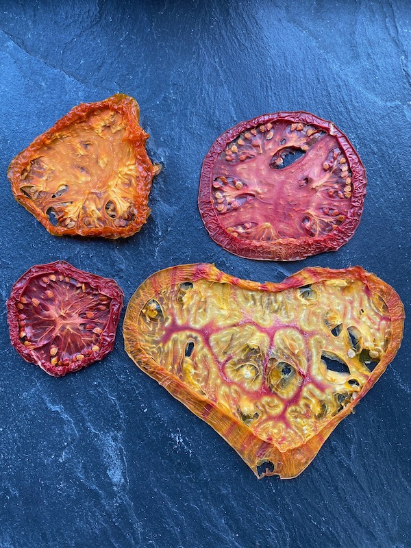 I slice tomatoes to 1/4 inch/6 mm thickness and dehydrate 18 hours at 55 C/130 F