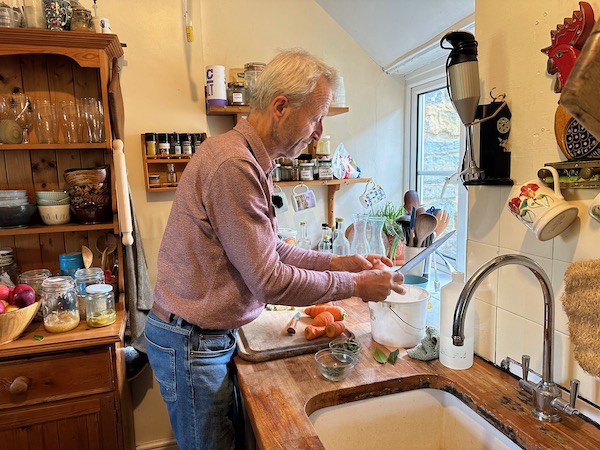 In my kitchen peeling garlic for the stew of squash and spinach