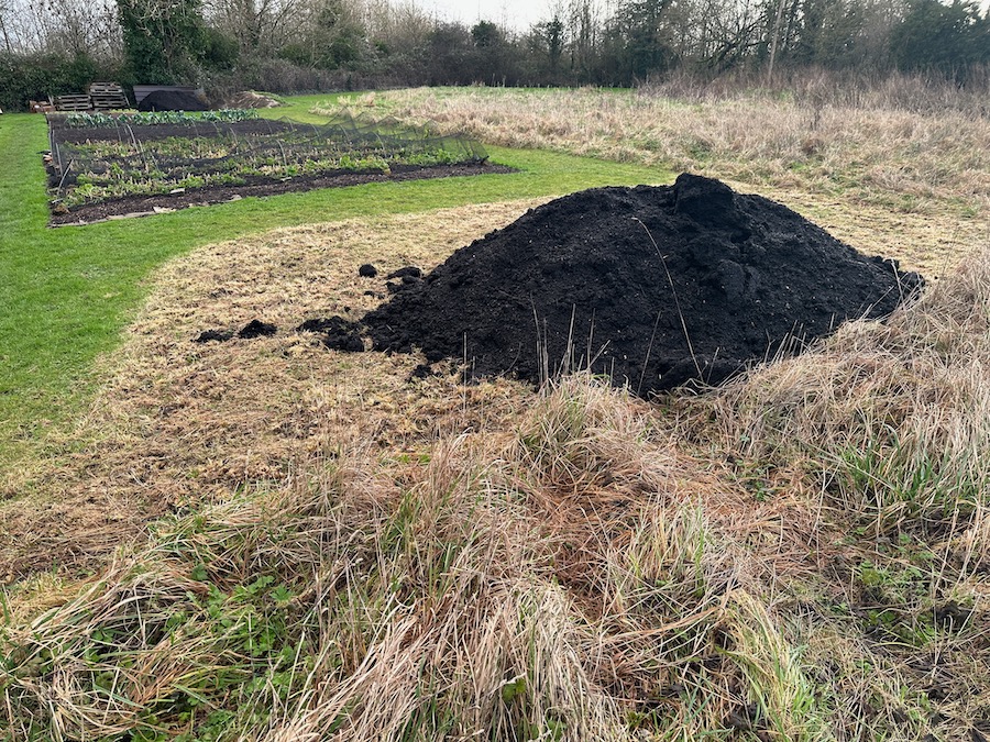 We mowed the rough grass and weeds, then took delivery of two tonnes green waste compost for no dig prep, to have black plastic on top