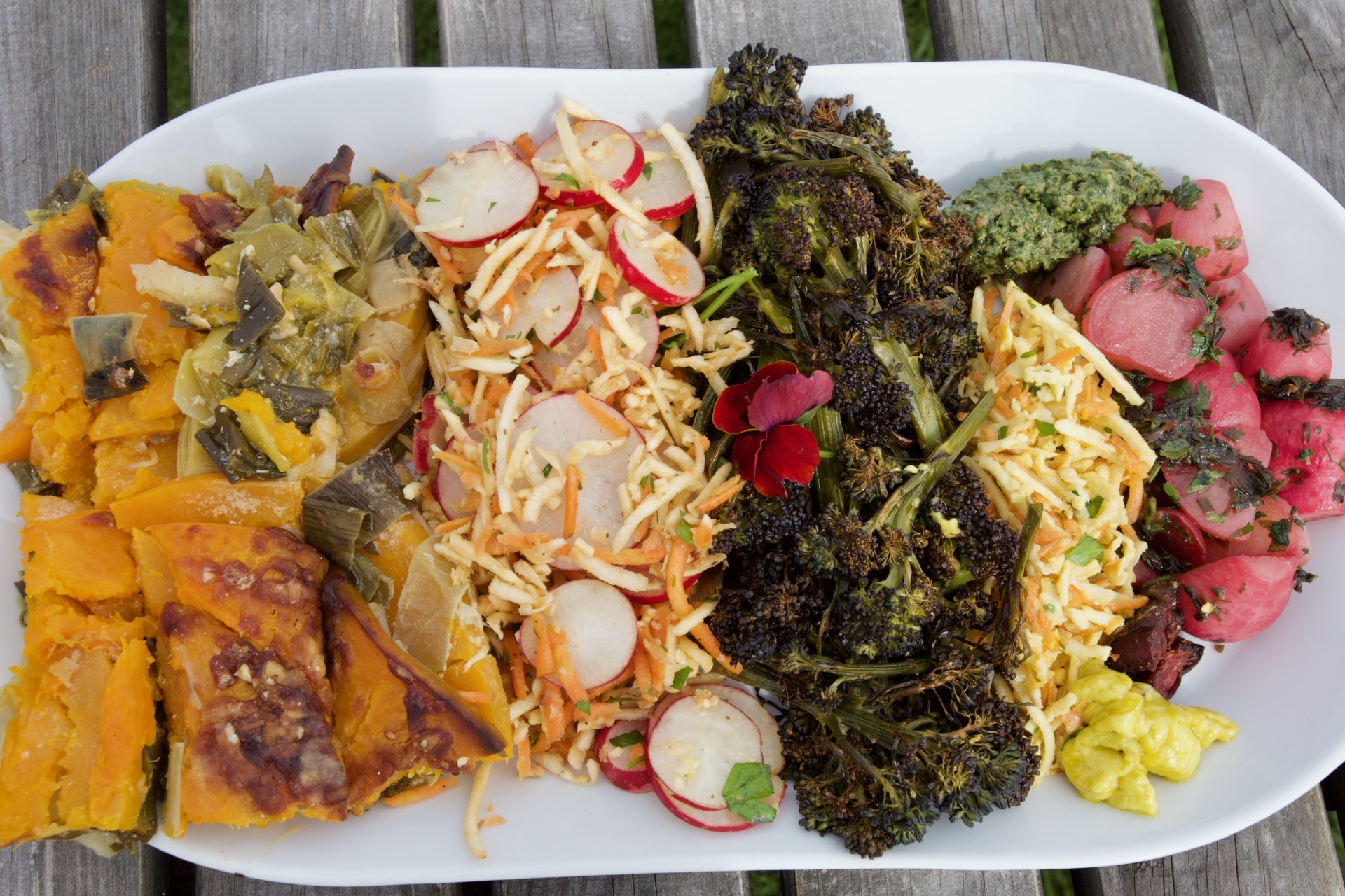 Course food by Cat Balaam includes squash tart, radish coleslaw, roasted broccoli, celeriac remoulade, braised radish. These dishes are in the Cookbook by Catherine.