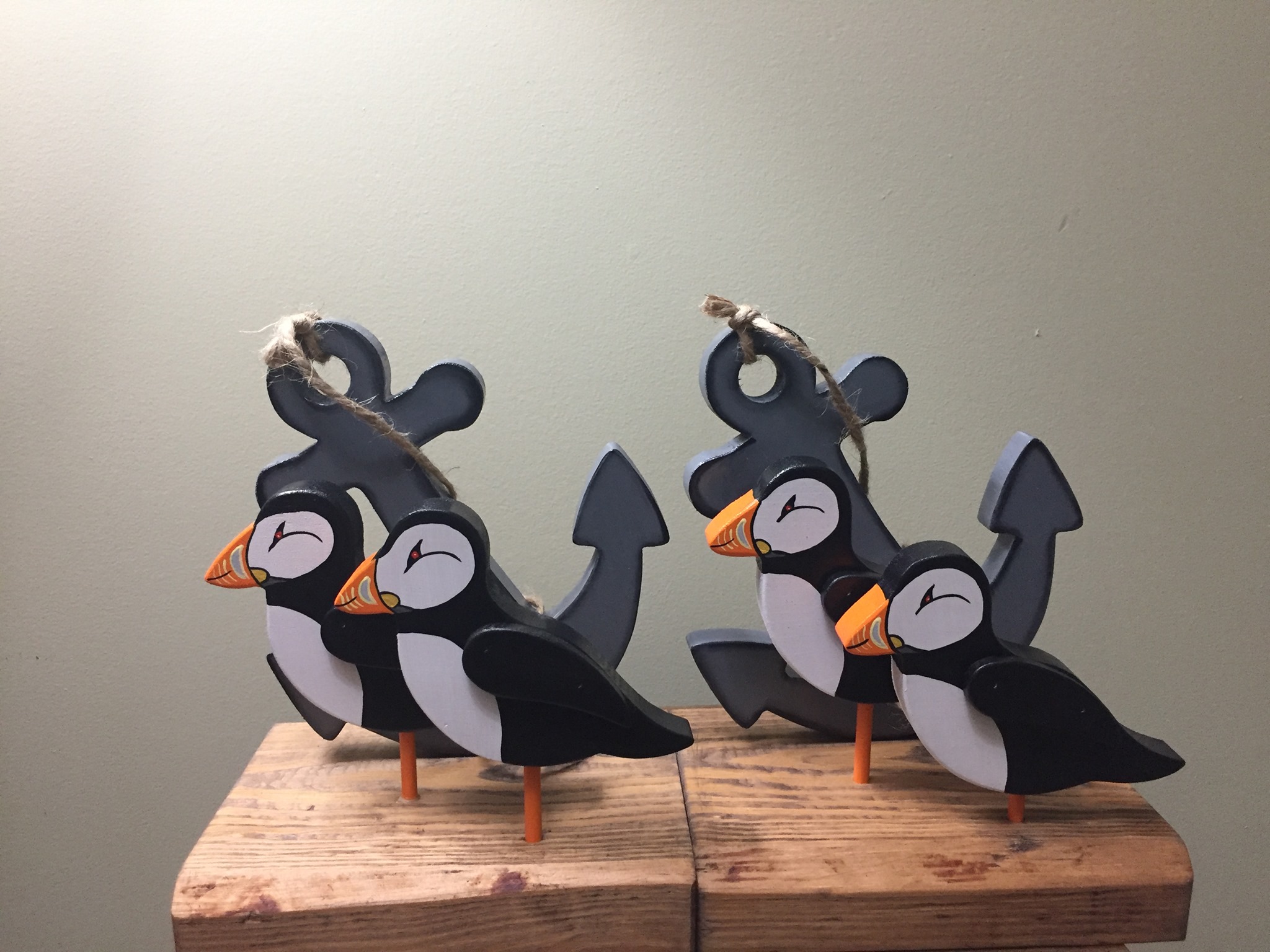 Two wooden puffins set in 4x4 blocks, backed by an anchor.