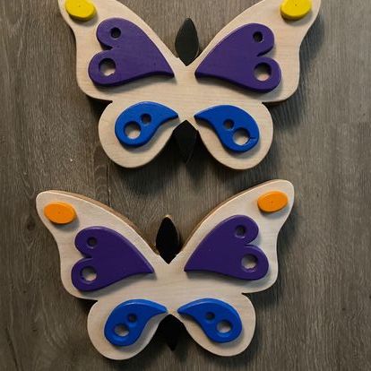 Wooden butterflies with colourful wings.
