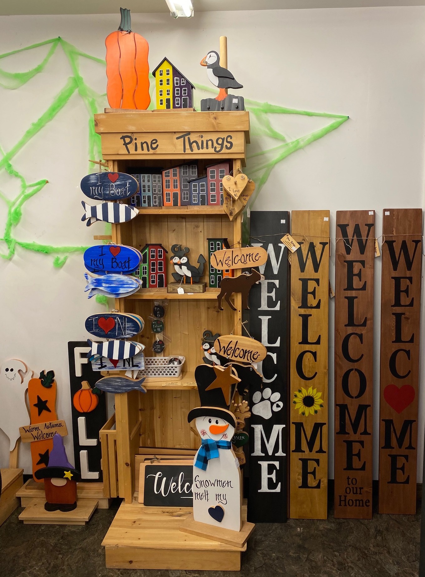 A shelf displaying various crafts made by the fine folks of Pine Things.