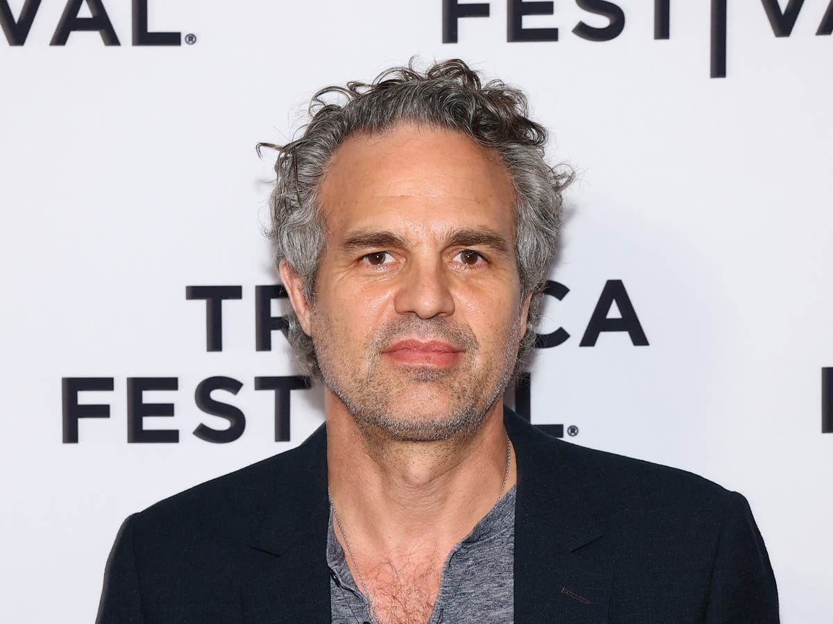 Mark Ruffalo in front of a step and repeat background