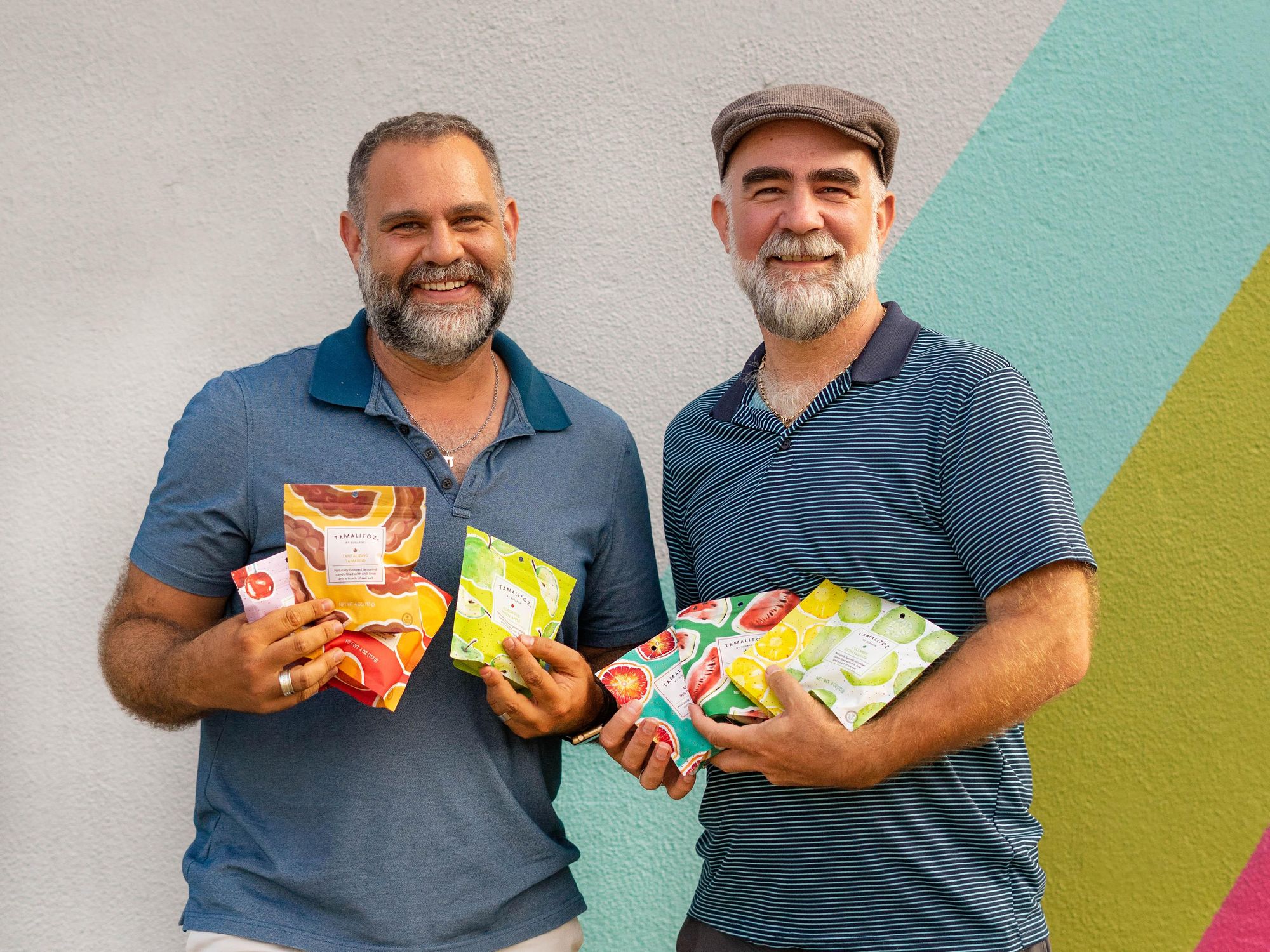 Austin-based Tamalitoz founders holding candy packages.