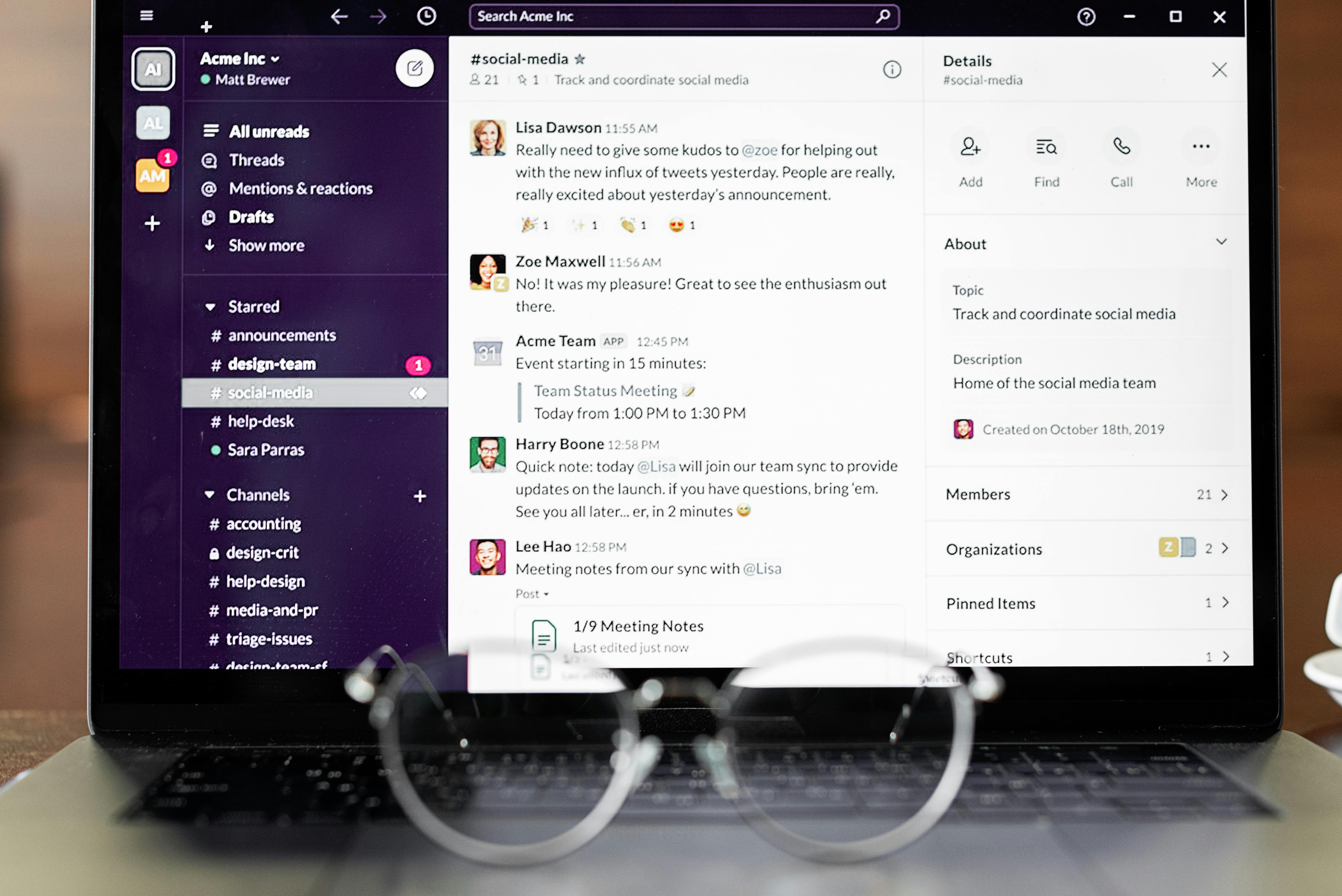 Laptop displaying Slack team communication interface with messages and channels visible.