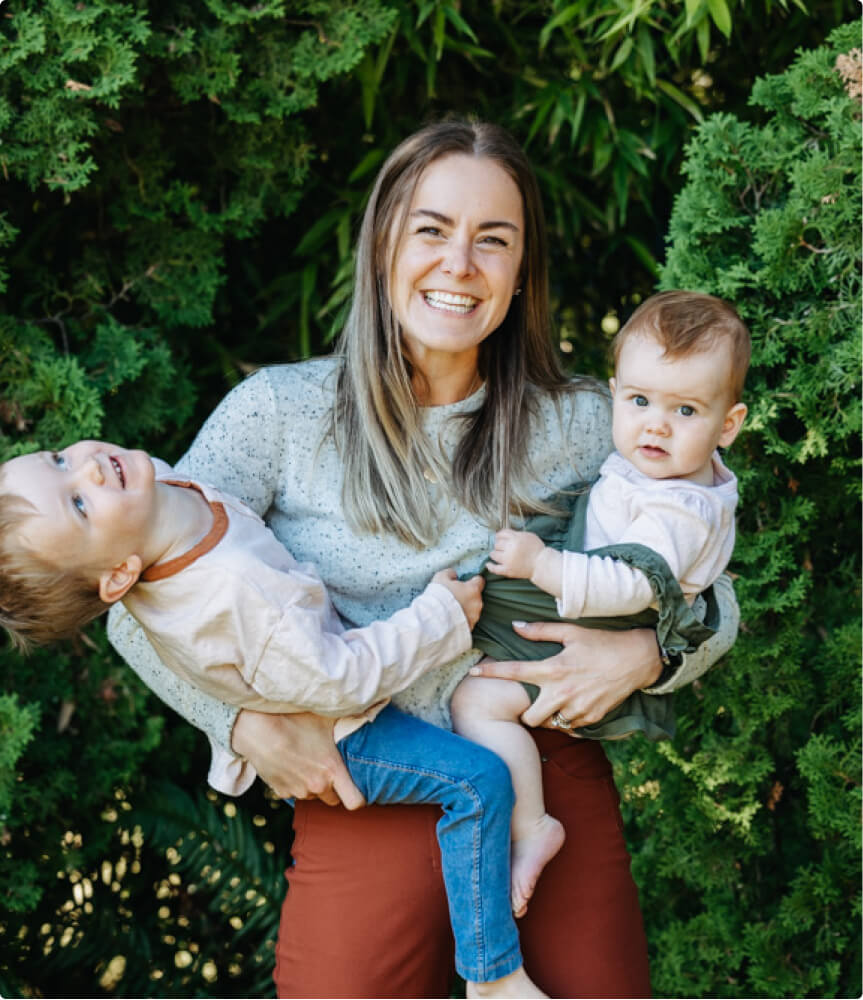 Renée Jordan holding her two kids.