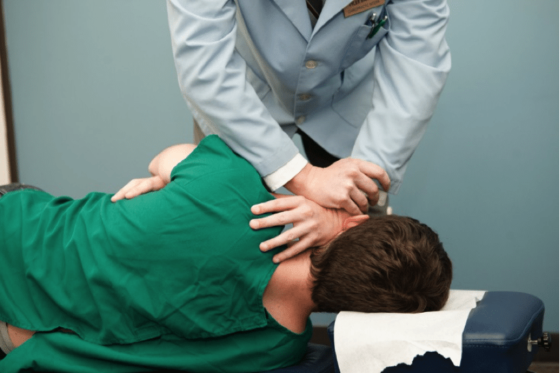 chiropractor explaining treatment to patient