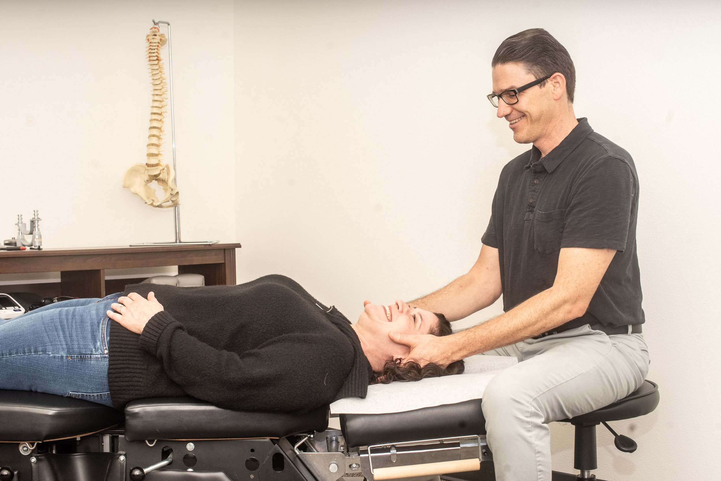 Chiropractor conducting initial examination