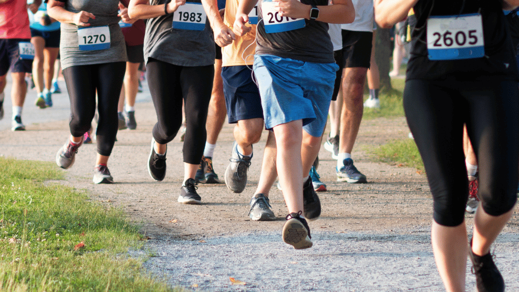 Group of people running 5k on gravel road
