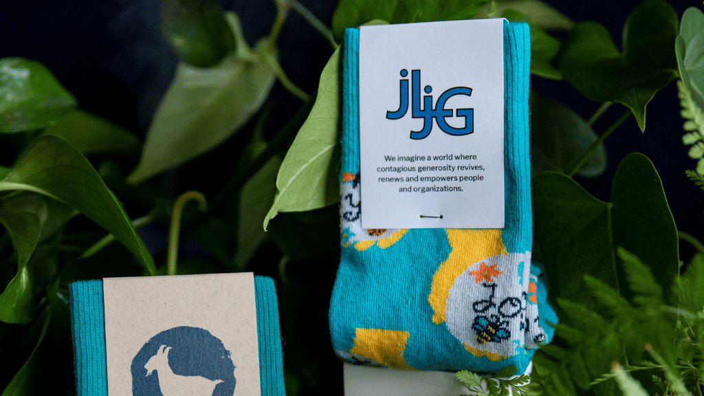 company logo on custom sock product with green lush background to increase branding awareness