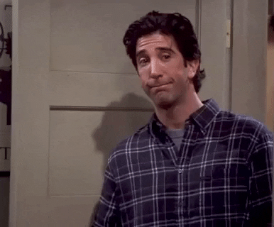 An animated gif of a character from the TV show 'Friends', played by Ross Geller, gesturing uncertainly and looking slightly uneasy, which could reflect hesitancy or awkwardness in a situation