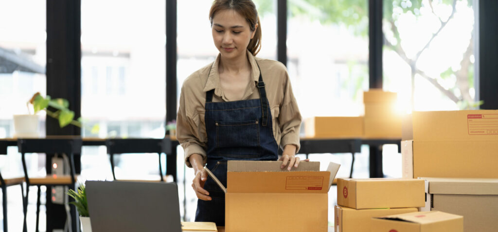 Startup Sme Small Business Entrepreneur Sme Or Freelance Asian Woman Using A Laptop With Box, Online Marketing Packaging Box And Delivery, Sme Concept