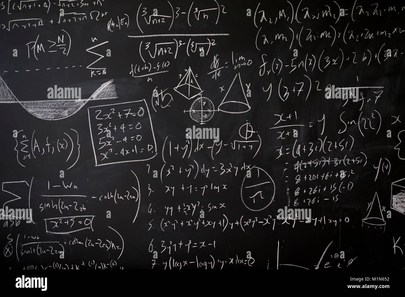 Chalkboard filled with mathematical equations and calculations