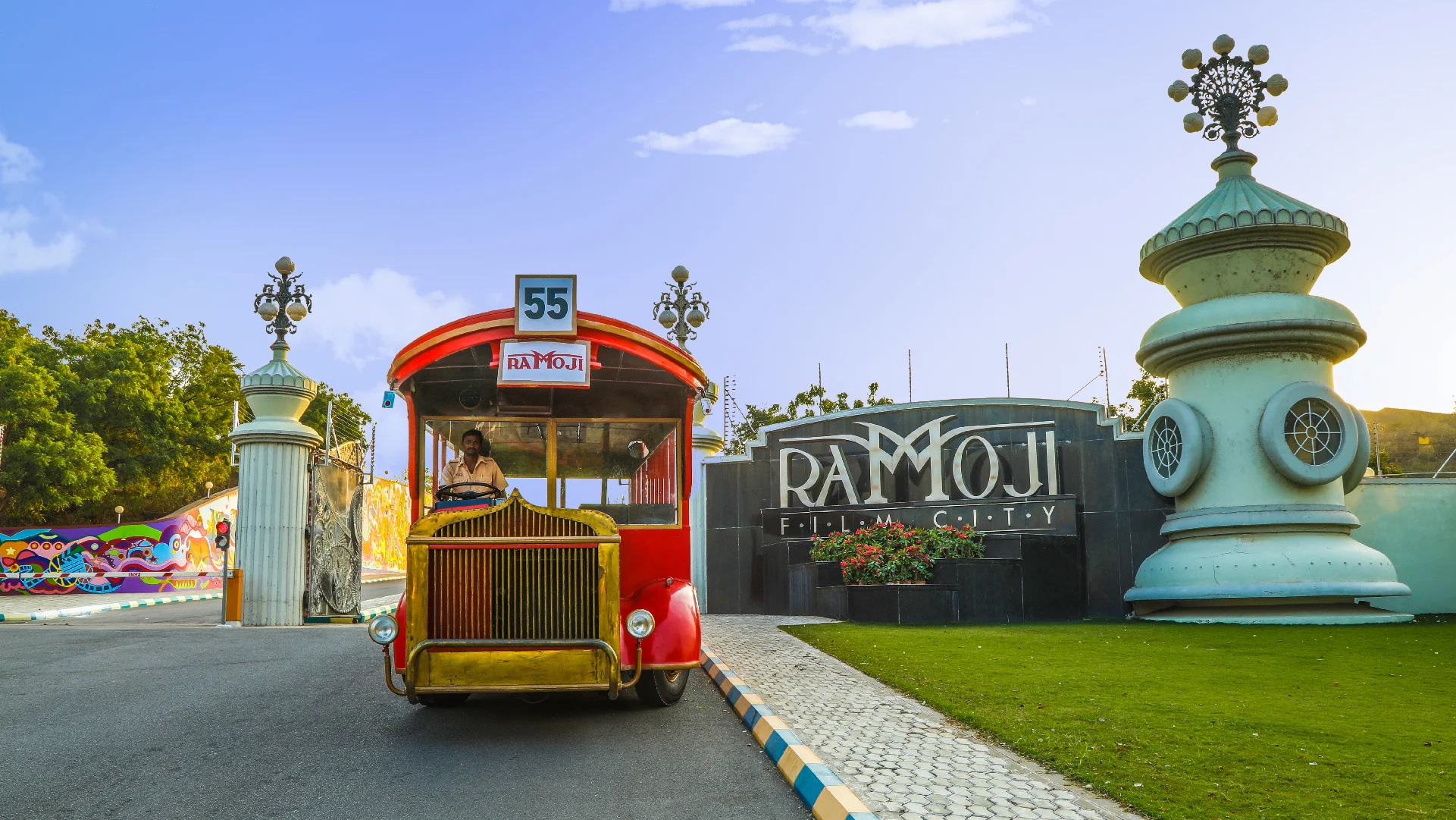 Vintage red tour bus entering Ramoji Film City, a top tourist attraction in Hyderabad - JKV Travel.