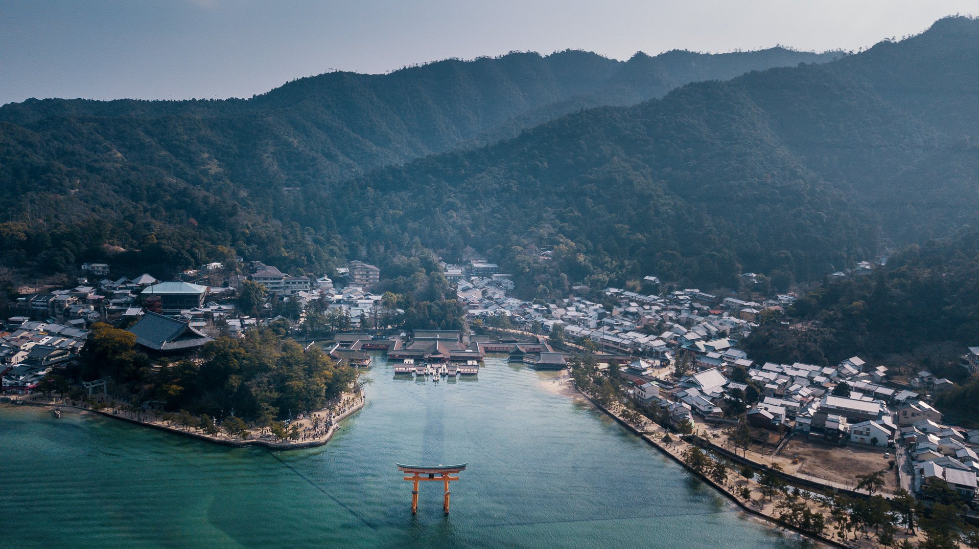 drone shot of red torii gate miyajima island hiroshima