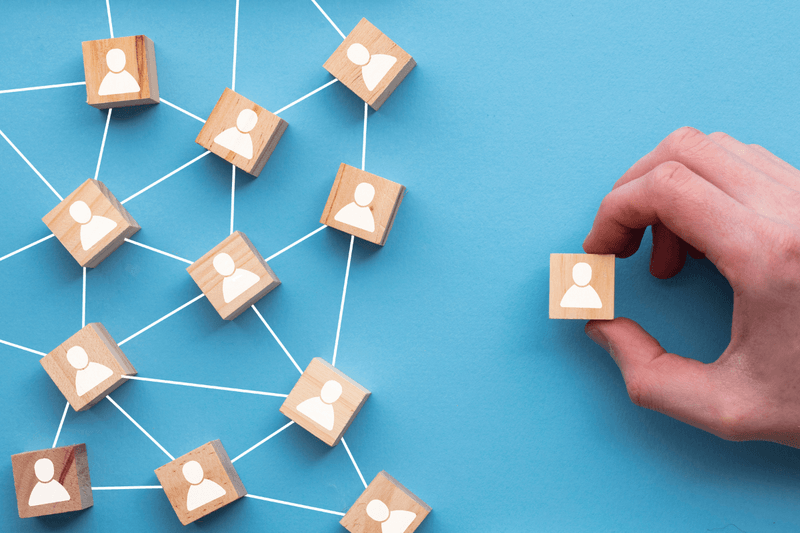 image of complex web of people and a hand picking only one