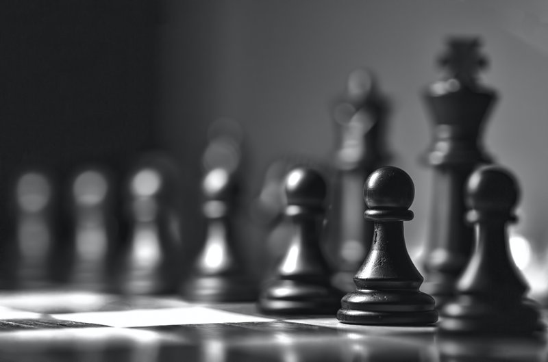 black chess pieces illustrating how well prepared a market entry strategy for Japan should be